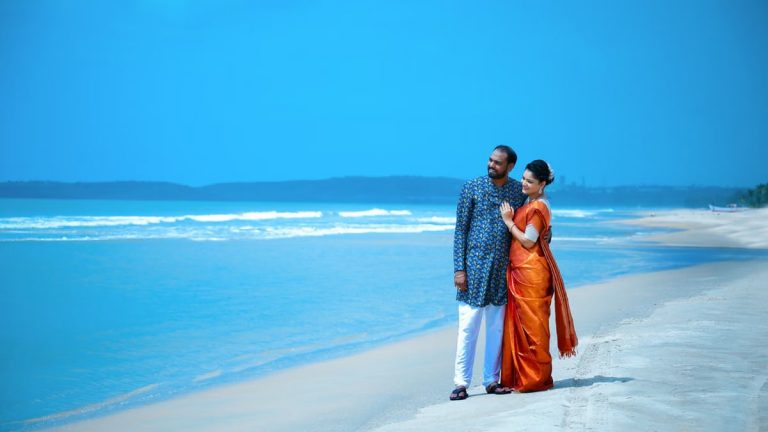 A couple in traditional attire enjoying a serene moment on a Hyderabad beach.